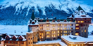 Escape to the enchanting Badrutt's Palace in St. Moritz with scenic First Class train journeys