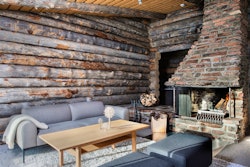Lounge with log fire, Javri Lodge, Finland