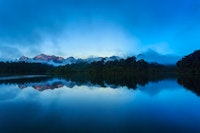 a sunrise over cheaw larn lake at the rainforest camp
