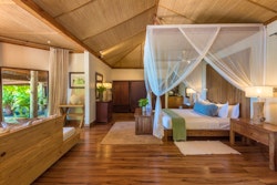 beach villa bedroom at denis private island seychelles