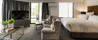 Family Suite Lounge and Bed at Hotel Montreal, Christchurch