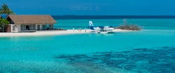Guests Descending from Private Sea Plane at Four Seasons Private Island Maldives at Voavah