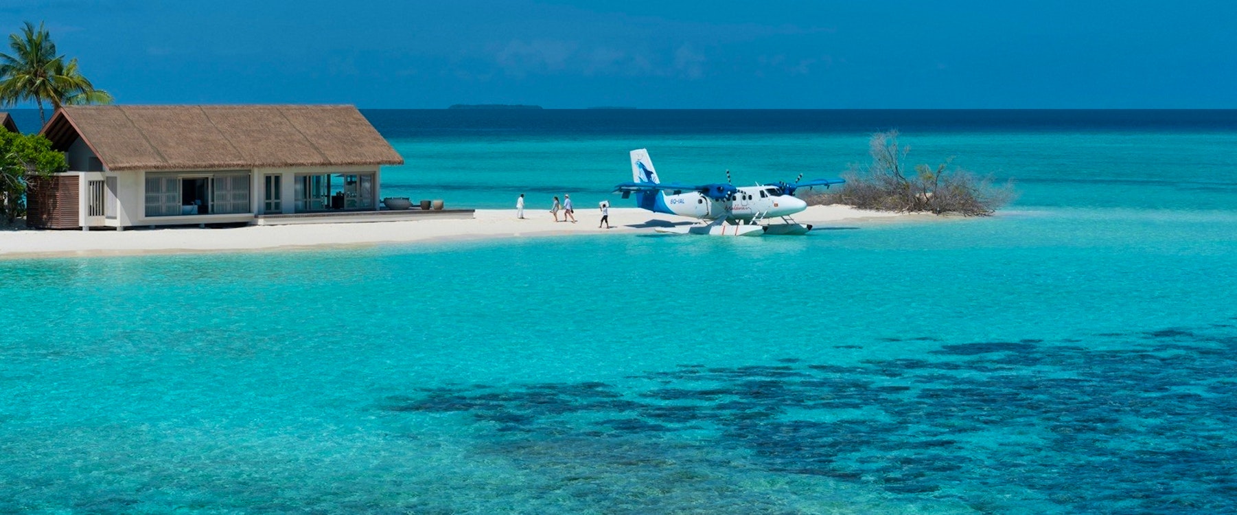 Guests Descending from Private Sea Plane at Four Seasons Private Island Maldives at Voavah