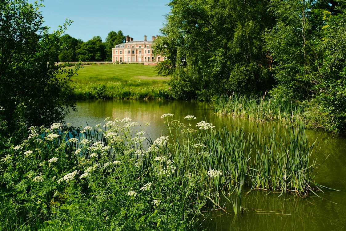 View of Heckfield Place from across the estate's lake