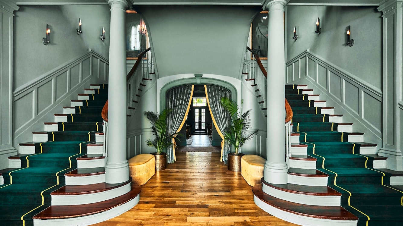 entrance hallway and grand staircase at the vanderbilt auberge resorts collection