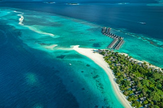 Escape to the Maldives for a luxury stay at this Four Seasons Resort right in the Baa Atoll