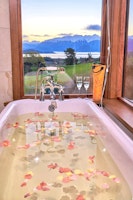 relaxing in bath at Cabot Lodge, Queenstown, South Island, New Zealand