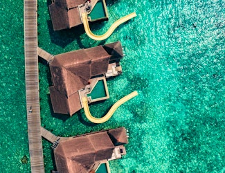 Enjoy gourmet dining and views of the glistening Indian Ocean at this spectacular resort in the Maldives