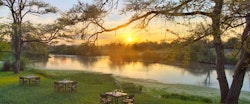 Dine with a sunset view at &Beyond Grumeti Serengeti Tented Camp