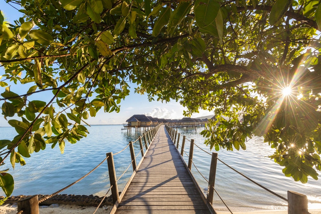 pontoon to overwater suites at le tahaa island resort  spa tahiti french polynesia