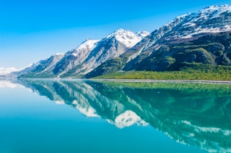 Enjoy a luxury cruise through breathtaking Alaska before boarding the iconic Rocky Mountaineer train