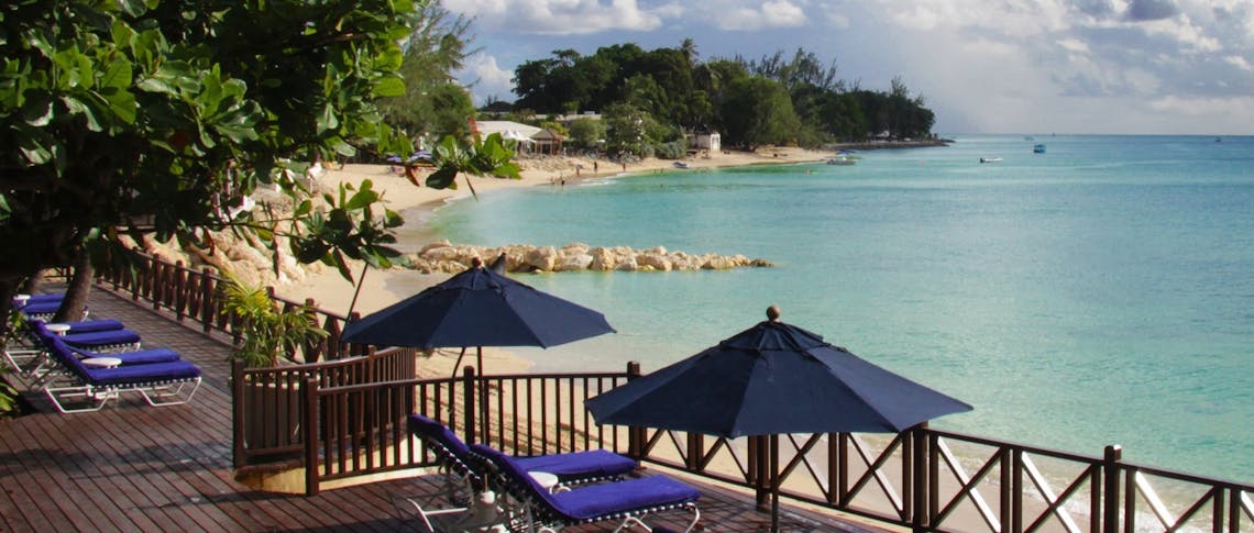 Relax on the terrace overlooking the ocean at The Sand Piper, Barbados